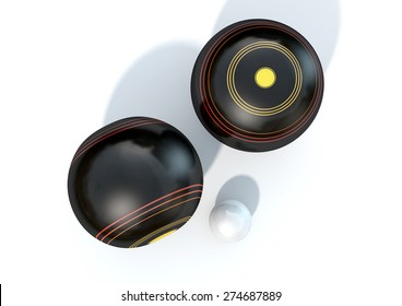 Two wooden lawn bowling balls surrounding a white jack on an isolated white studio background