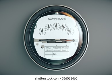 Typical residential analog electric meter with transparent plactic case showing household consumption in kilowatt hours. Electric power usage.