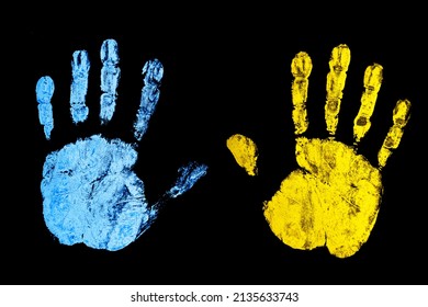 Ukraine flag color. Stop the war background. Open hand paint imprint. Symbolic gesture of STOP. One hand supporting another. Palm isolated on black.