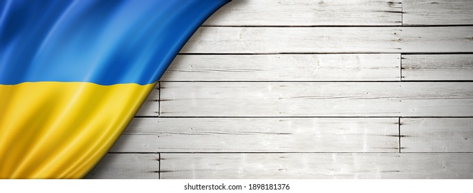 Ukraine flag on old white wall. Horizontal panoramic banner. 3D illustration