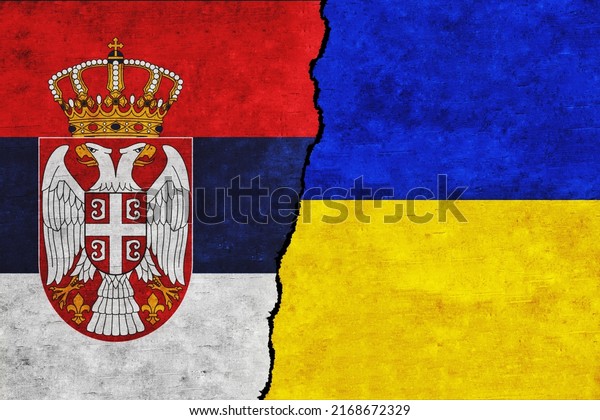 Ukraine and\
Serbia painted flags on a wall with a crack. Ukraine and Serbia\
relations. Serbia and Ukraine flags\
together