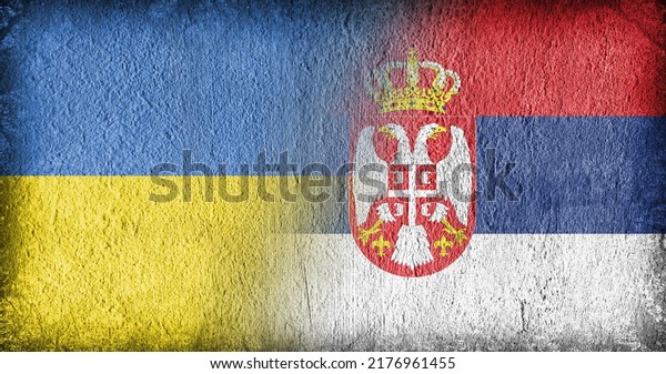 Ukrainian and Serbian flag on concrete, divided in\
the middle
