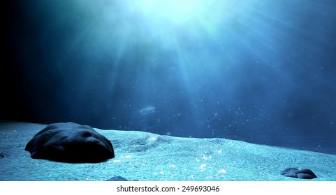 An Underwater Scene At The Bottom Of The Ocean Floor Showing Sand And Emanating Sunlight Beaming Through