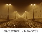 A uniquely atmospheric capture of a foggy, sepia-toned cobblestone street, flanked by glowing streetlamps and an iron-wrought fence, evoking a sense of serene mystery.