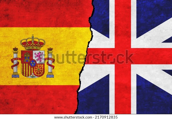 United\
Kingdom and Spain painted flags on a wall with a crack. Spain and\
Britain relations. UK and Spain flags\
together