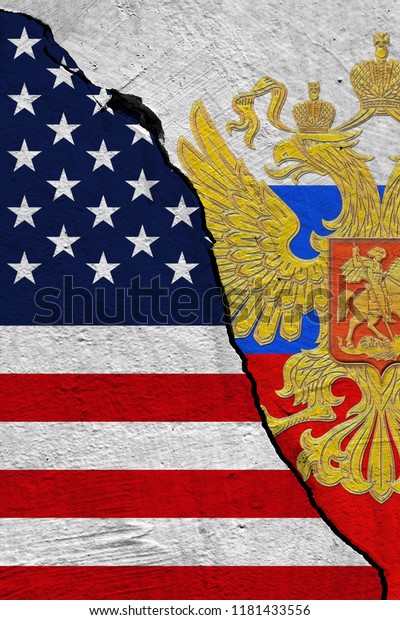 United States of America and Russia flag separated\
by a crack on a\
wall.