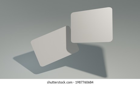 Universal Mockup Of Two Bank Gift Cards With Shadows On A Light Gray Background 3D Rendering. Side View.