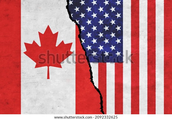 USA and Canada painted flags on a wall with a\
crack. USA and Canada relations. Canada and United States of\
America flags\
together