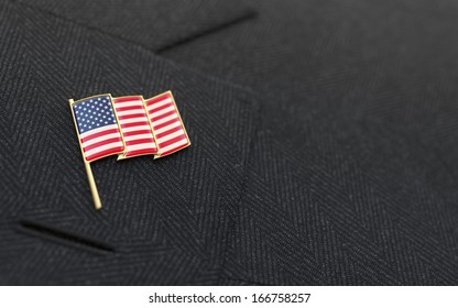 USA Flag Lapel Pin On The Collar Of A Business Suit Jacket Shows Patriotism