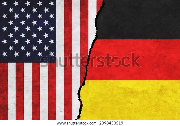 USA and Germany painted flags on a wall with a\
crack. USA and Germany relations. Germany and United States of\
America flags together. USA vs\
Germany