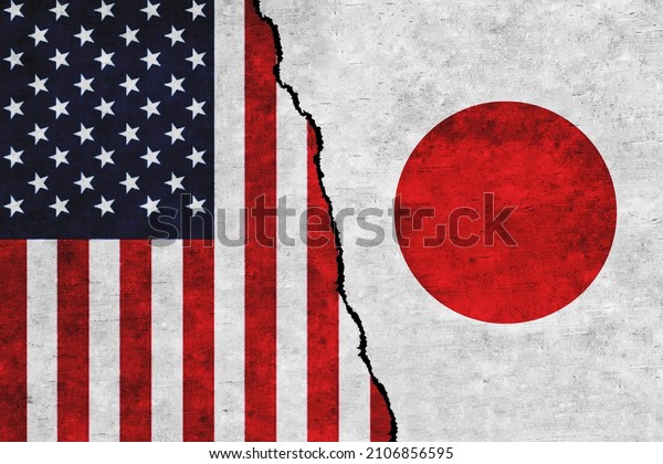USA and Japan painted flags\
on a wall with a crack. United States of America and Japan\
relations
