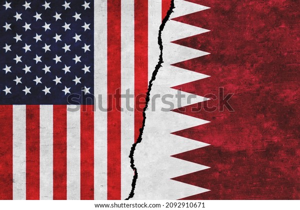 USA and Qatar painted flags on a wall with a crack.\
USA and Qatar conflict. Qatar and United States of America flags\
together. USA vs\
Qatar