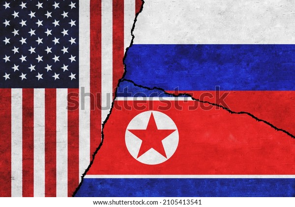 USA,\
Russia and North Korea painted flags on a wall with a crack. United\
States of America, North Korea and Russia\
conflict