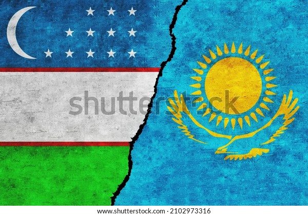 Uzbekistan and Kazakhstan painted flags on a\
wall with a crack. Uzbekistan and Kazakhstan relations. Kazakhstan\
and Uzbekistan flags\
together