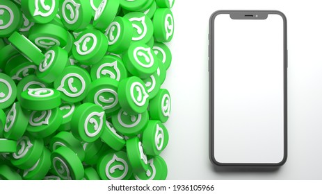 Valencia, Spain - March, 2021: heap of WhatsApp icons with mobile phone mockup isolated on a white background in 3D rendering. WhatsApp is an online social media network. Social media messaging app