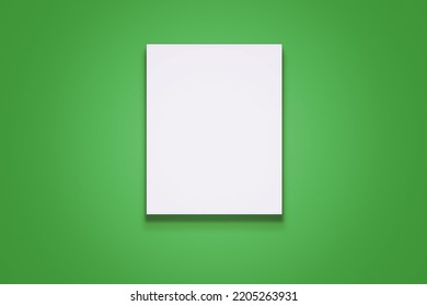 Vertical White Blank Poster With Portrait Orientation Hanging On Green Wall Front View