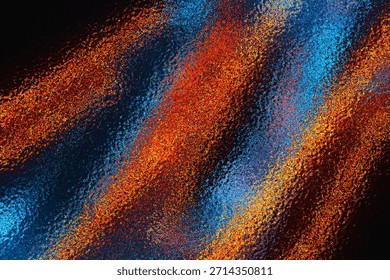 A vibrant abstract background featuring a unique grainy and stippled texture Bright orange and vivid blue hues stream diagonally across a dark backdrop, creating a highenergy visual contrast