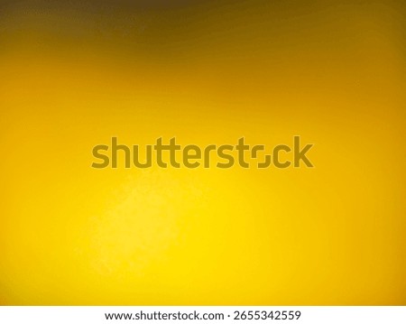 A vibrant abstract image centered on a bright, luminous yellow glow. The light radiates outwards, with the color gradually darkening to a deep golden-yellow and fading to a dark brown shadow 