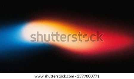 A vibrant abstract image featuring a blurred streak of light transitioning from blue to orange and red. The dark background enhances the glow and energy, suggesting motion and possibly a cosmic theme.
