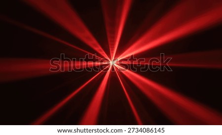 A vibrant red light source radiates numerous beams outwards from the center against a dark, smoky background, creating a dynamic starburst effect.