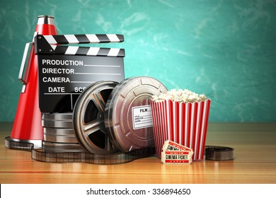 Video, movie, cinema vintage production concept. Film reels, clapperboard, tickets, popcorn and megaphone. 3d
