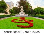 Vienna, Austria. Watercolor illustration. The Mozart Monument (German: Mozart-Denkmal). Architect Karl Konig (1841–1915) and sculptor Viktor Tilgner (1844–1896). Burggarten park