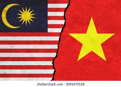 Vietnam and Malaysia painted flags on a wall with a crack. Vietnam and Malaysia conflict. Malaysia and Vietnam flags together. Vietnam vs Malaysia