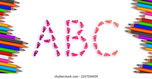 View from above of a white surface with the letters ABC in the form of small feet as a sign for first graders, school enrollment and a new beginning. Colored pencils in rainbow colors on the edge - Powered by Shutterstock