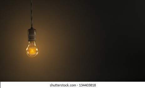 Vintage Hanging Light Bulb Over Dark Background