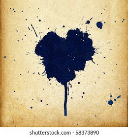 Vintage heart shaped blue ink stains on old paper background.