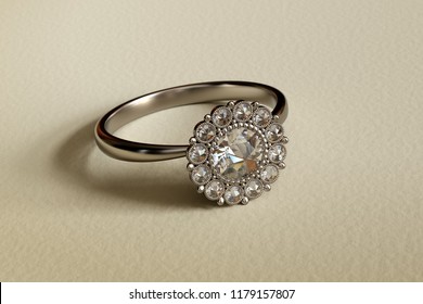 Vintage Platinum Engagement Ring With Dutch Rose Cut Diamonds Halo Setting On Textured Beige Background. 3D Illustration