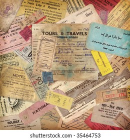 vintage travel background made of lots of old tickets, boarding passes, hotel reception cards and other documents