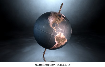 A Vintage World Globe Tilted And Standing On A Central Axis On An Isolated Spotlit Dark Background