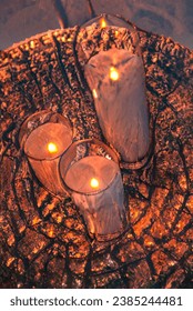 Visualization of an Illustration of a copper tray supporting lighting .Three lit candles on a tray