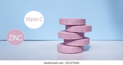 Vitamin C With Black Elderberry Extract And Zinc On A White-blue Background. Two Icons Of Vitamin C And Zinc Are Located On The Background