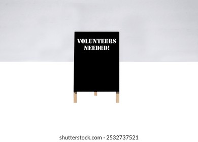 VOLUNTIERS NEEDED. A-Frame Sign. Sidewalk chalk board. Advertising sign. Old Black Chalk board. Store signage. Black board advertising sign. Common Sayings. Good Advice. Free Advice. VOLUNTIERS NEEDED - Powered by Shutterstock