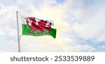 Wales flag waving on sky background. 3D Rendering