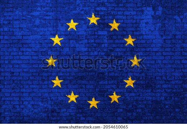 wall of\
bricks painted with the flag of Europe, blue with yellow stars. 3d\
background. Concept of social barriers of immigration, divisions,\
and political conflicts in\
Europe.