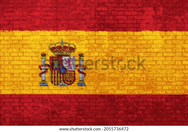 Wall of bricks painted\
with the flag of Spain, red and yellow colors. 3D background.\
Concept of social barriers of immigration, divisions, and political\
conflicts in Spain.