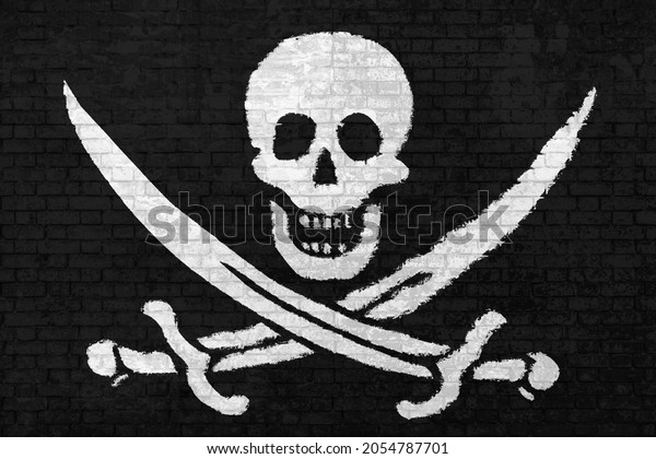 wall of bricks painted with the Pirate Flag of\
Calico Jack Rackham, white skull and swords crossing on black wall\
3D background. Concept of social barriers and divisions or\
political\
conflicts.