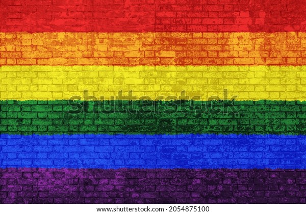 Wall of bricks painted with the rainbow flag.\
Colorful flag of peace symbol and gay pride. Concept of social\
barriers and discrimination, divisions, and political conflicts. 3D\
background