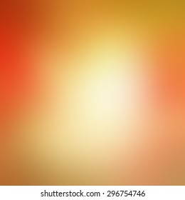 warm autumn background blur in red pink gold yellow and orange with white center and smooth shiny background texture, colorful background design