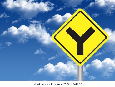 Warning road sign Y intersection. Clouds and yellow road signs.
