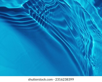 Closeup​ blur​ abstract​ of​ surface​ blue​ water. Abstract​ of​ surface​ blue​ water​ reflected​ with​ sunlight​ for​ background.Top​ view​ of blue​ water.​ Water​ splashed​ use​ for​ graphic​ design