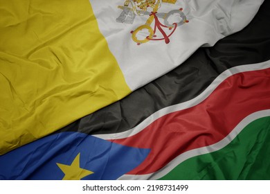 Waving Colorful Flag Of South Sudan And National Flag Of Vatican City. Macro.3d Illustration