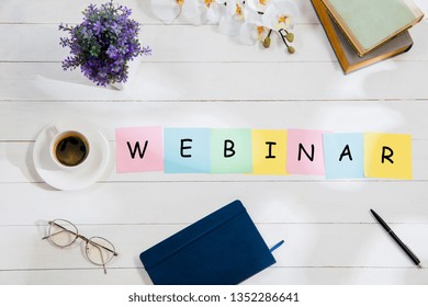 WEBINAR. Message at colorful note papers on a desk background. Lifestyle, business, office, motivation, plan, success, goal and management concept. Top or flat lay view.
