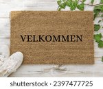 "welcome" in danish language "velkommen" on a doormat 