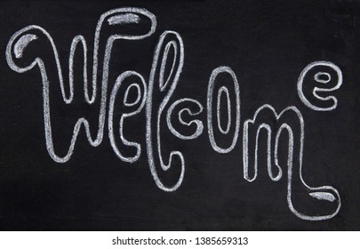 Welcome handdrawn chalk lettering inscription on blackboard. Welcome handwritten sign on chalkboard. Welcoming tag for coffee shop or bar. Hipster cafe or bar decor element. White chalk lettering sign - Powered by Shutterstock