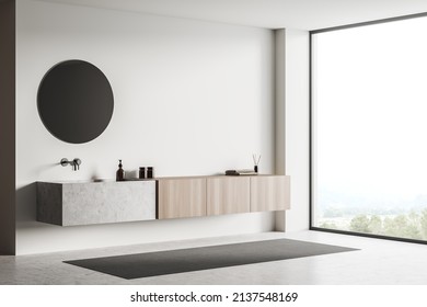 White Bathing Room Interior With Sink And Round Mirror, Side View, Carpet On Grey Concrete Floor. Modern Hotel Corner With Panoramic Window. Mockup Copy Space Wall, 3D Rendering