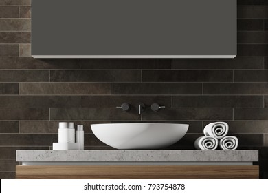 White Bathroom Sink Near A Black Brick Wall With A Large Mirror Hanging Above It. Front View. 3d Rendering